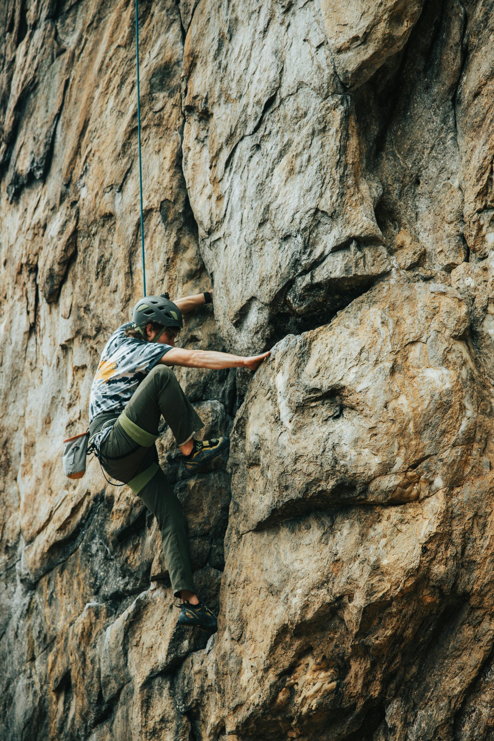 Man performing rock climbing with a safety harnesses 