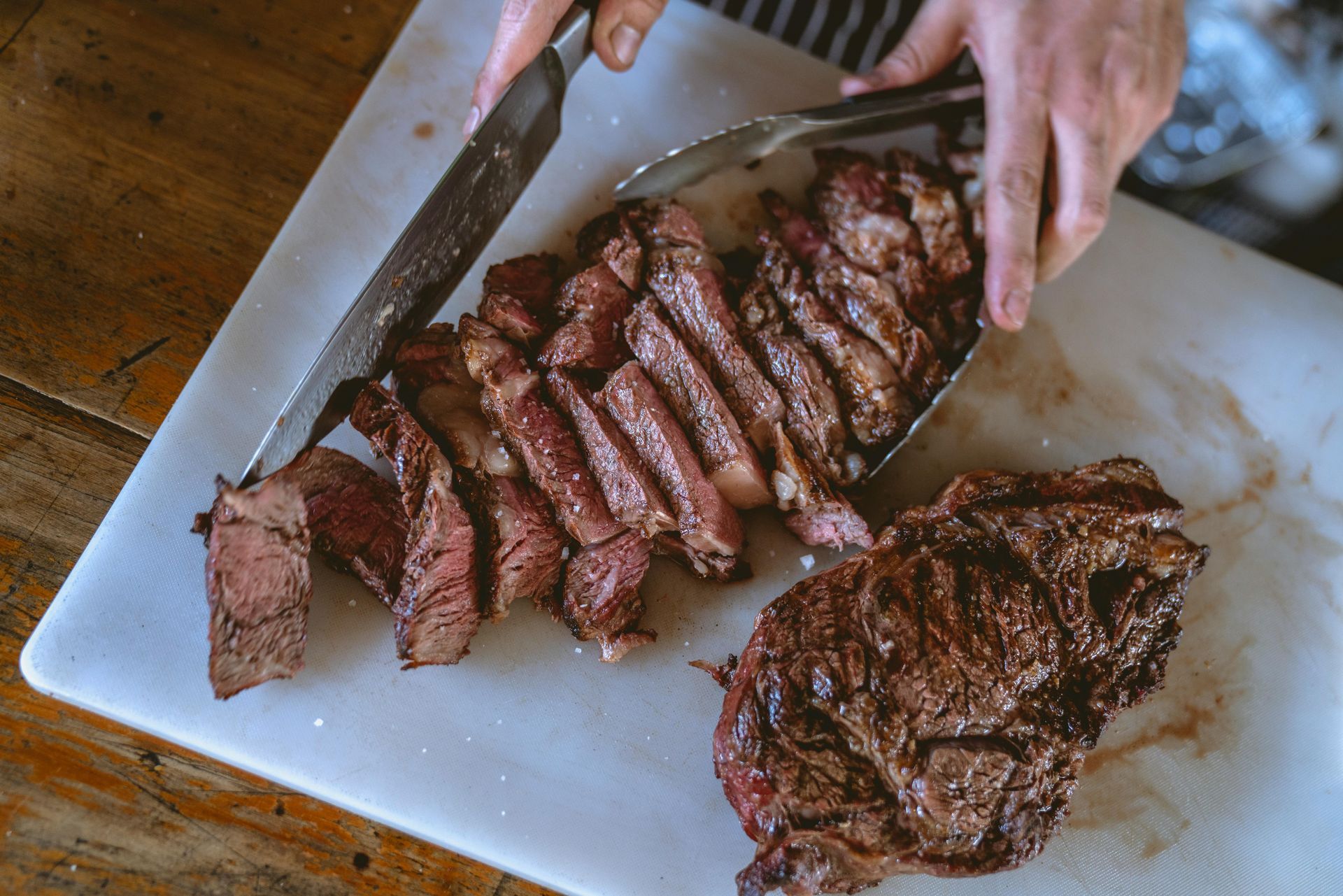 Large fillet of steaks being cut up into smaller slices