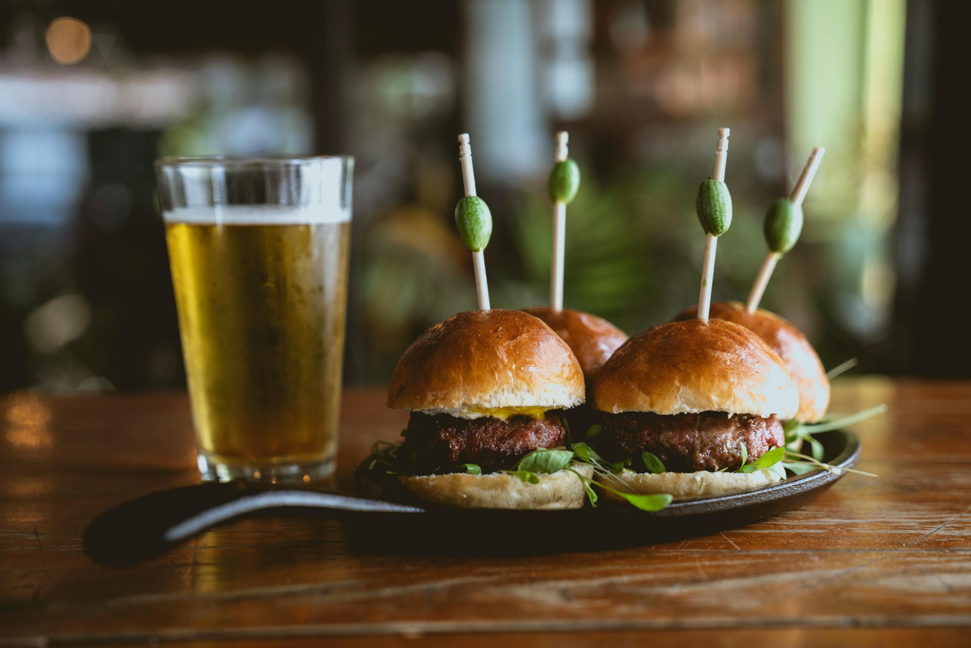 Slider burgers with beer on table at a bar and grill