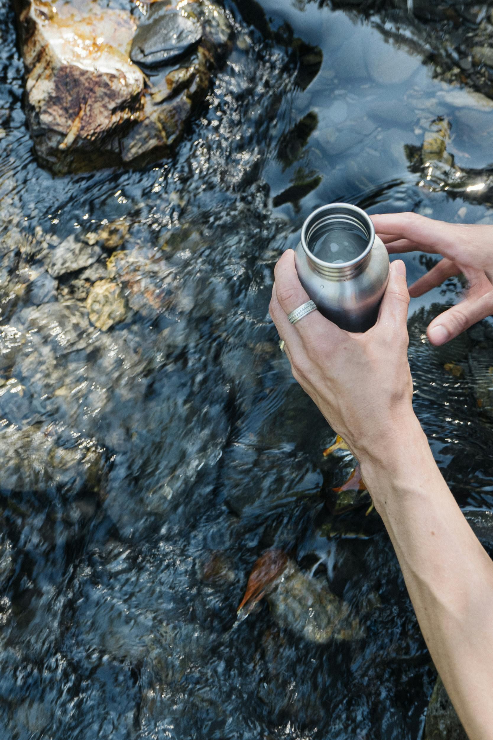 Water bottle being filled up for a day of riding out on the trails