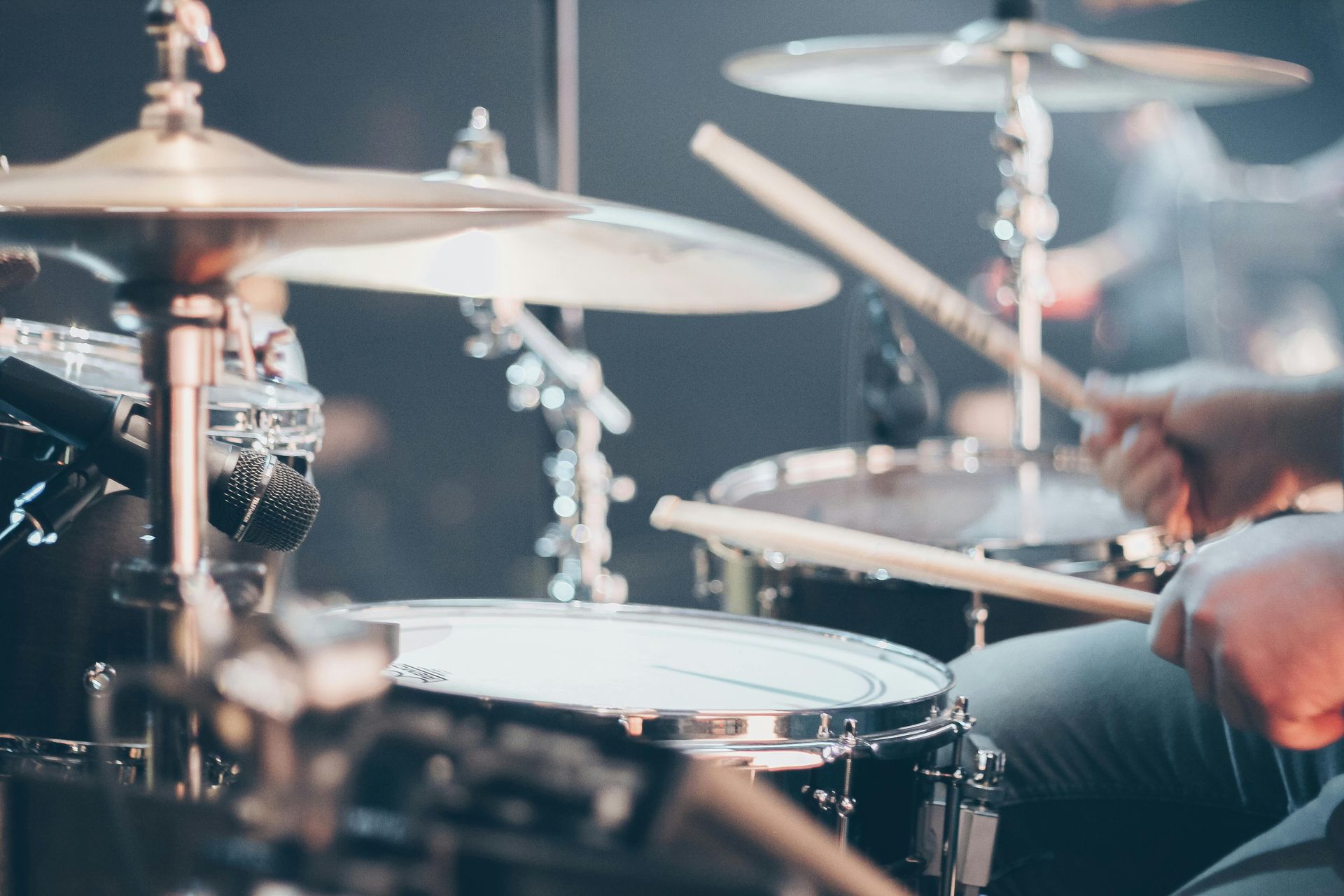 A drummer playing music to a live audience