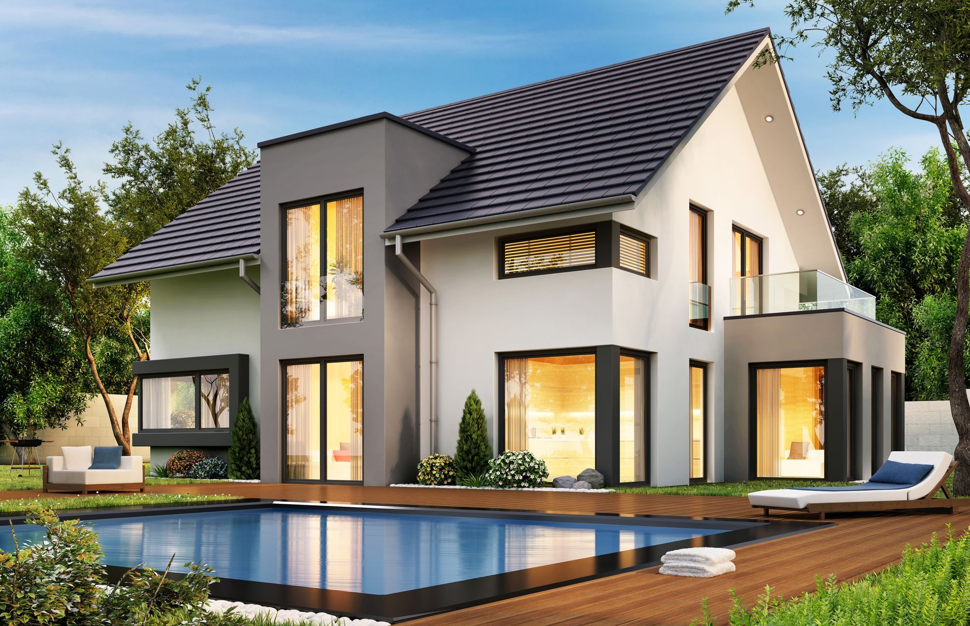 Maison blanche moderne de deux étages avec piscine, terrasse en bois et grandes fenêtres au crépuscule