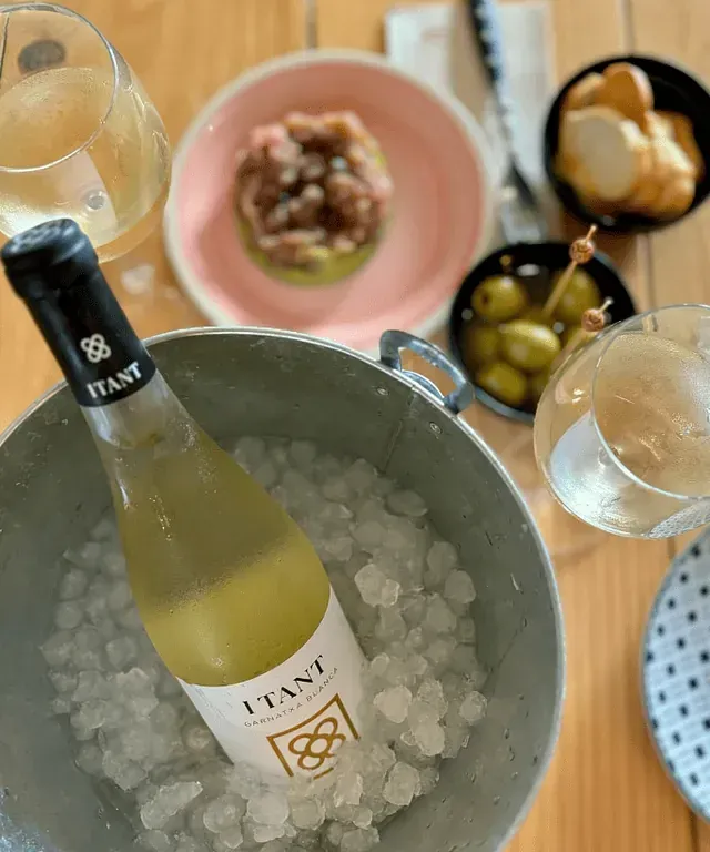 Una botella de vino Itani está en un cubo de hielo.