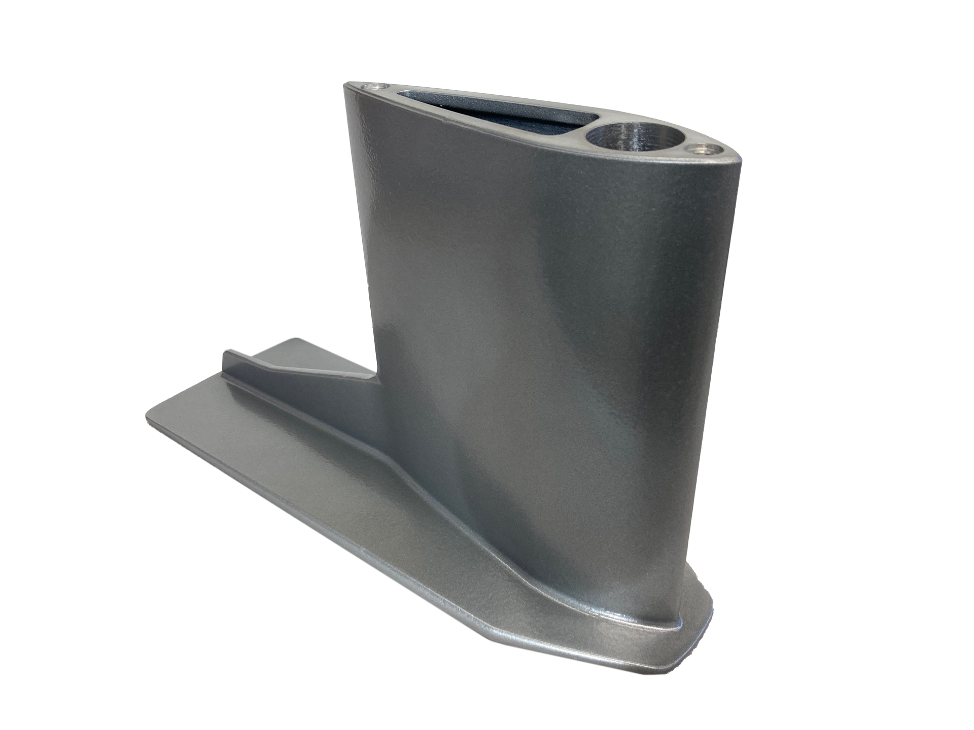 Ein graues Objekt liegt auf einer weißen Oberfläche.