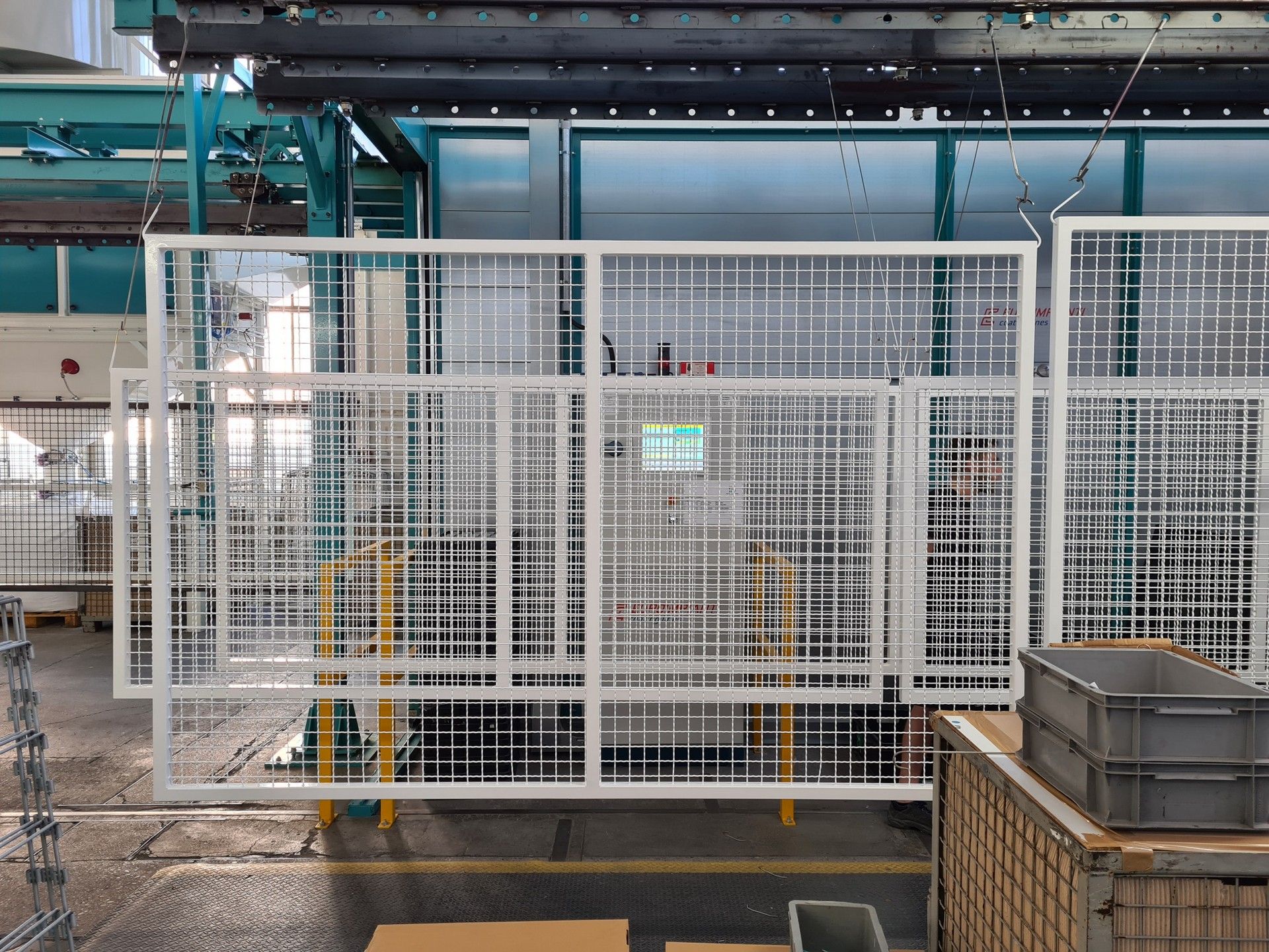 Eine Lagerhalle mit einem Zaun und Kisten auf dem Boden