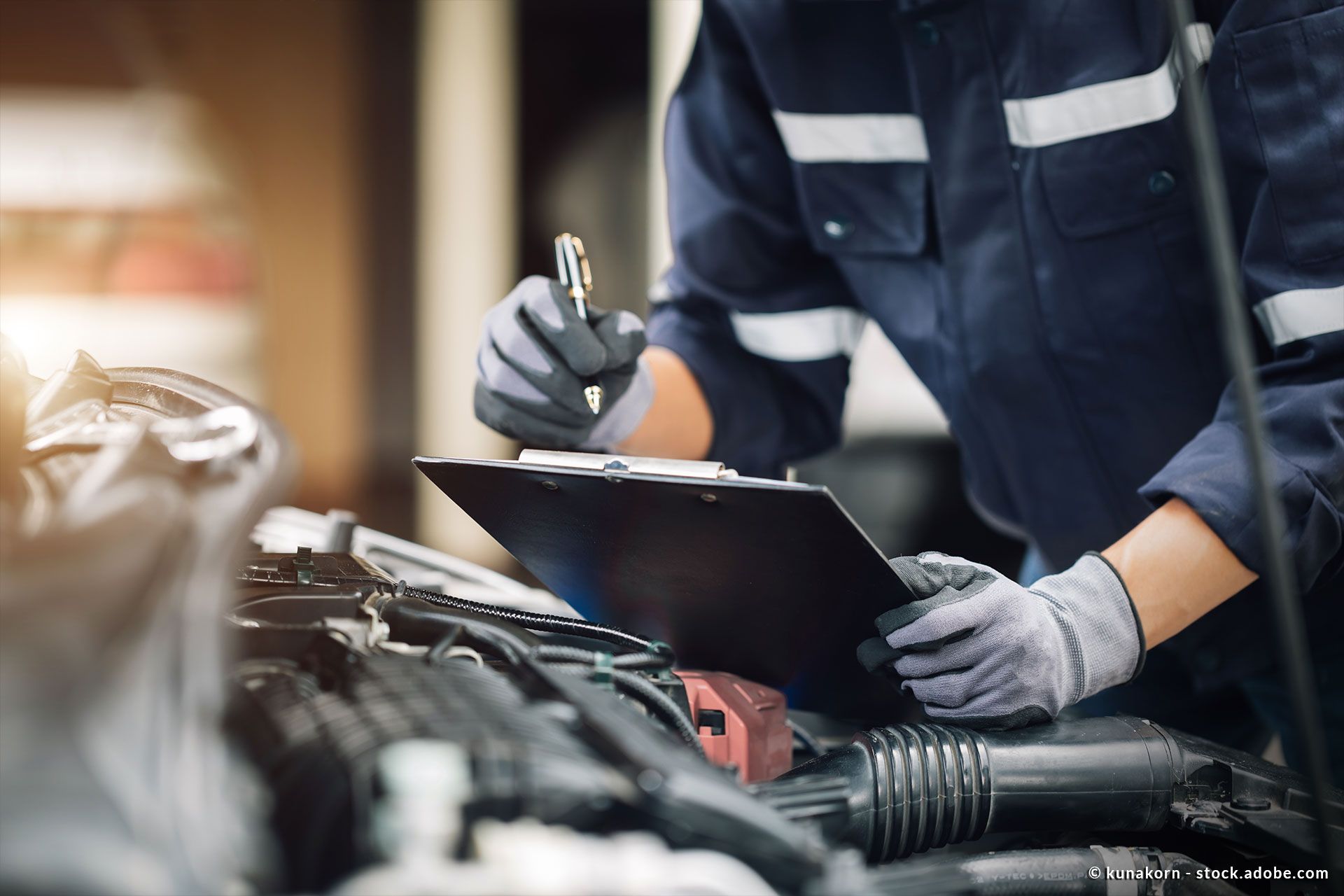 ein Mann steht mit einem Klemmbrett vor einem Auto