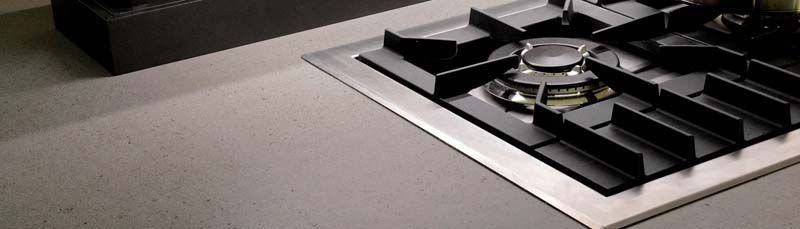 Una estufa de gas está colocada encima de una encimera en una cocina.