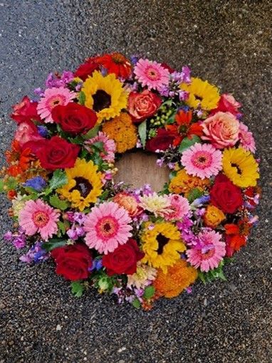 Ein Kranz aus bunten Blumen liegt auf dem Boden