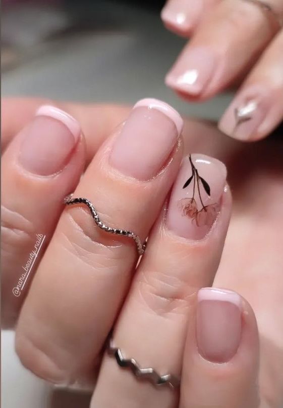 Un primer plano de las uñas de una mujer con anillos en ellas.