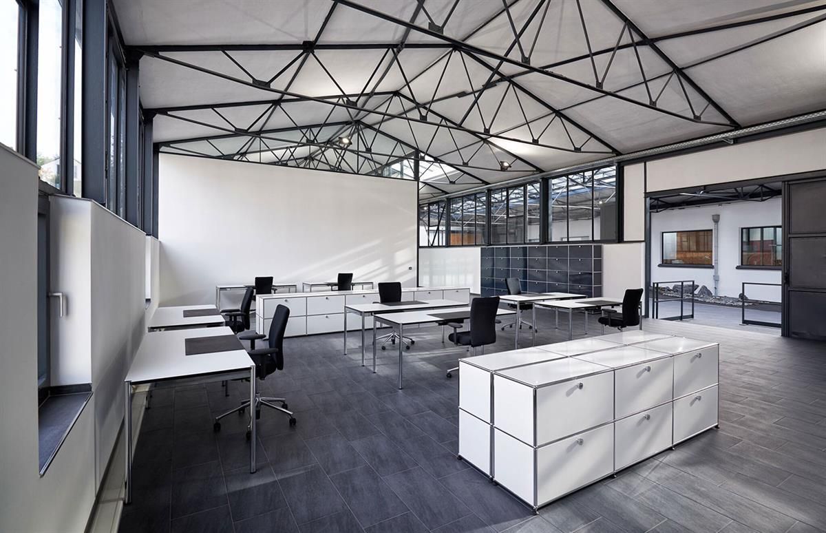 Ein großes Büro mit vielen Schreibtischen und Stühlen