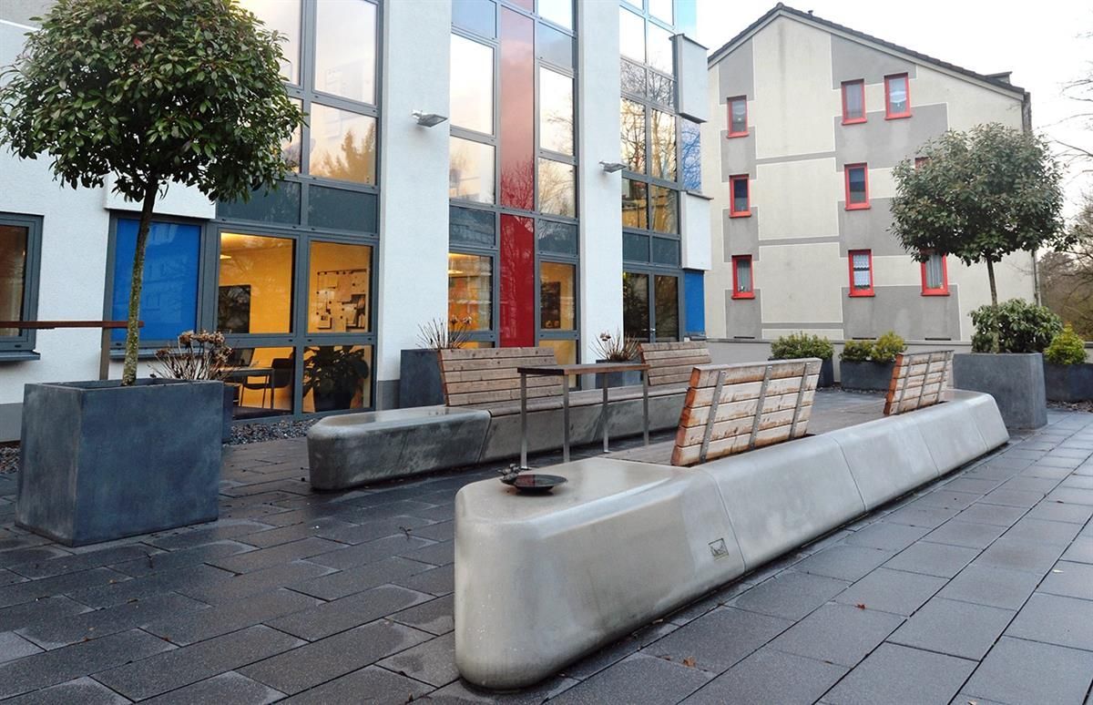 Ein Gebäude mit einer Reihe von Bänken davor