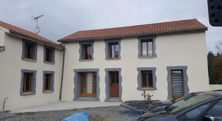 Une maison avec les rebords des fenêtres gris.