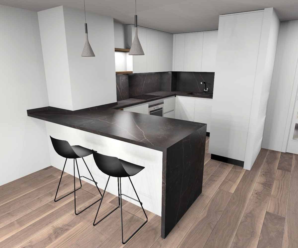 Una cocina con gabinetes blancos y encimeras negras.