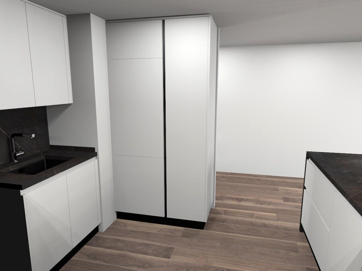 Una cocina con gabinetes blancos y encimeras negras.
