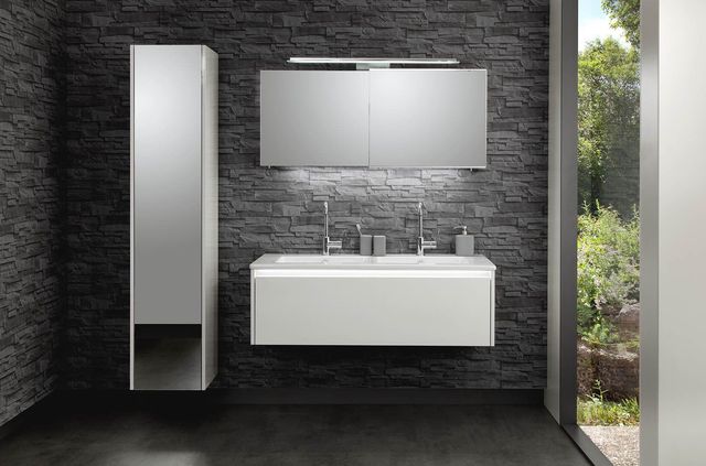 Une salle de bains avec des meubles blancs.
