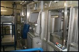 Intérieur d'un laboratoire stérile. Équipement en acier inoxydable, tambour bleu et petit chariot.