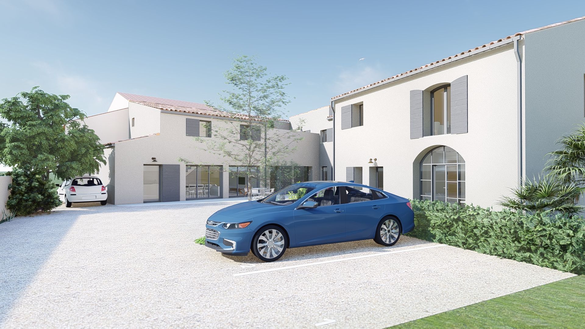 Maisons blanches modernes avec une voiture bleue garée dans une allée lumineuse.