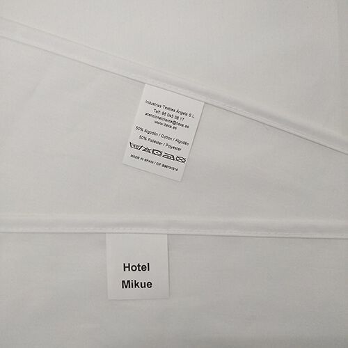 Una sábana blanca con una etiqueta que dice Hotel Mikue.