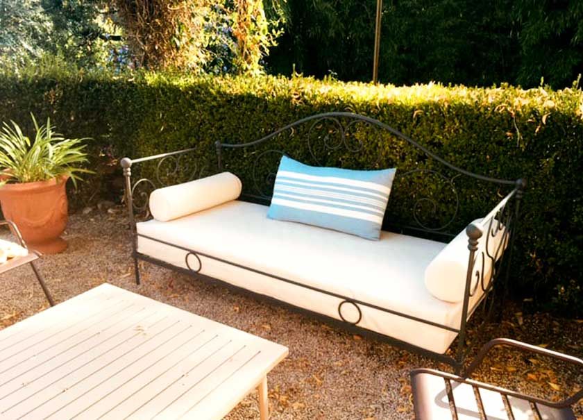 Un sofá con una almohada de rayas azules y blancas encima.