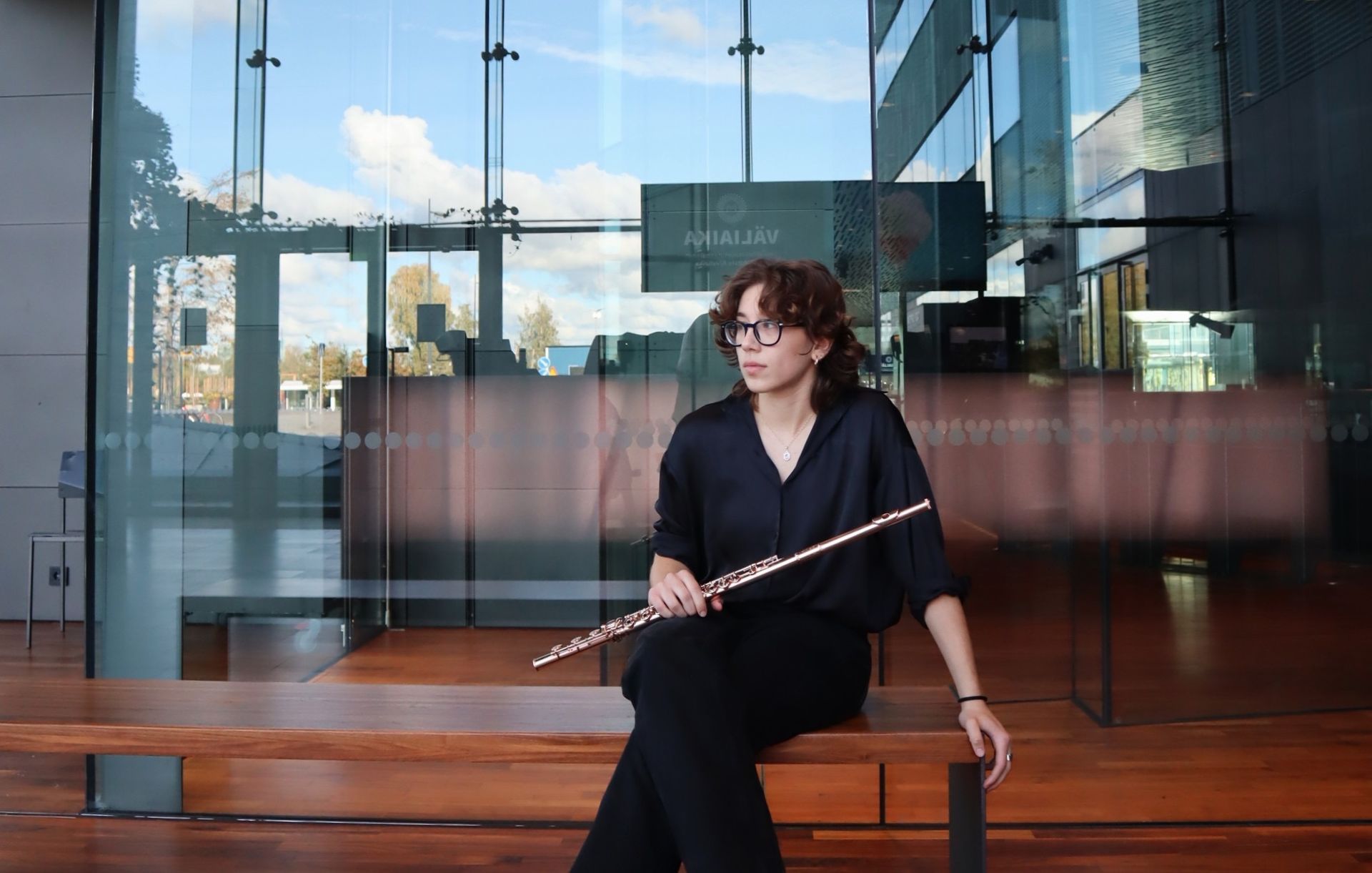 Ein Orchester spielt unter freiem Himmel. Die Musiker spielen Geige, sind schwarz gekleidet 