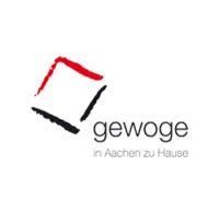 A logo for a company called gewoge in aachen zu hause.