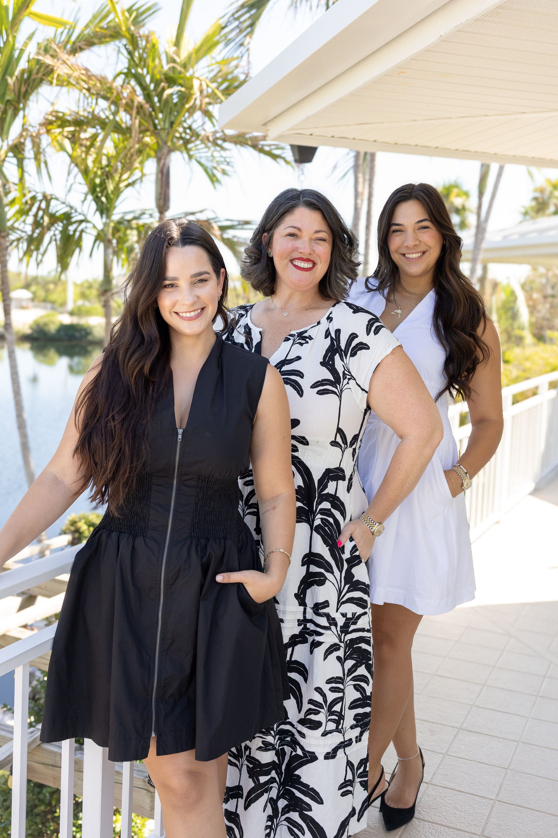Meet the team: Mallory Pinto (Owner) and Riley Woodstock (Rental Manager), and Melany Massaro (Office Manager) with photos and beach-themed design.