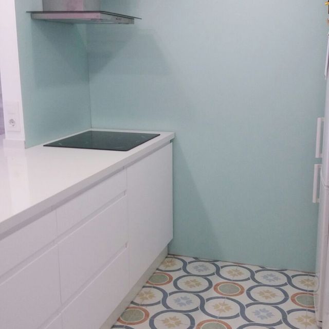 Una cocina con gabinetes blancos y un horno de estufa.