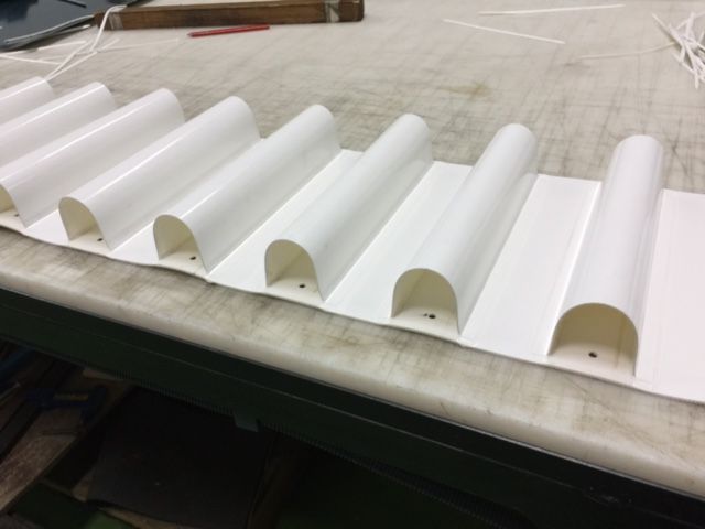 Una fila de tubos blancos están sobre una mesa.