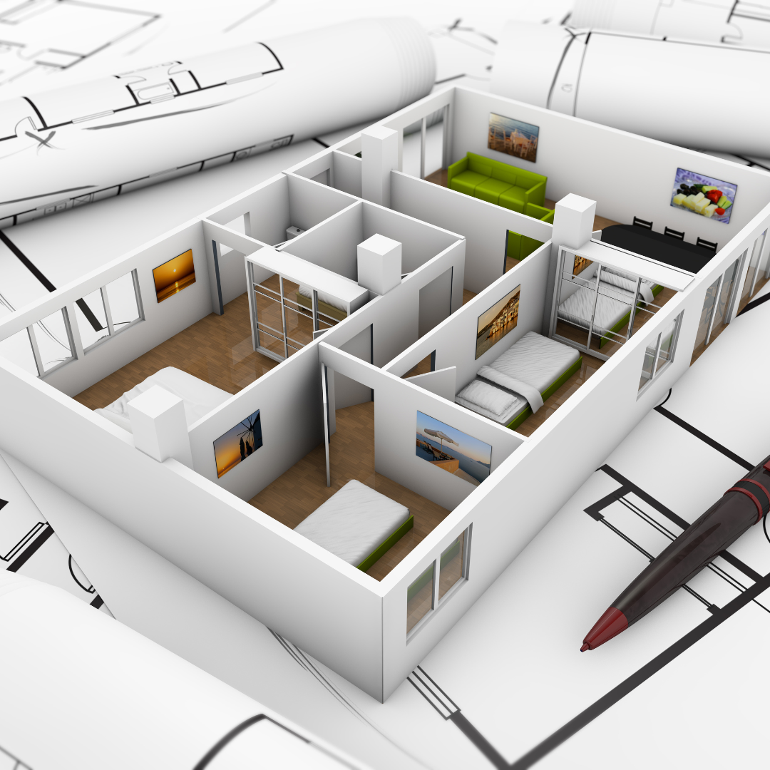 A small model house is sitting on top of a blueprint