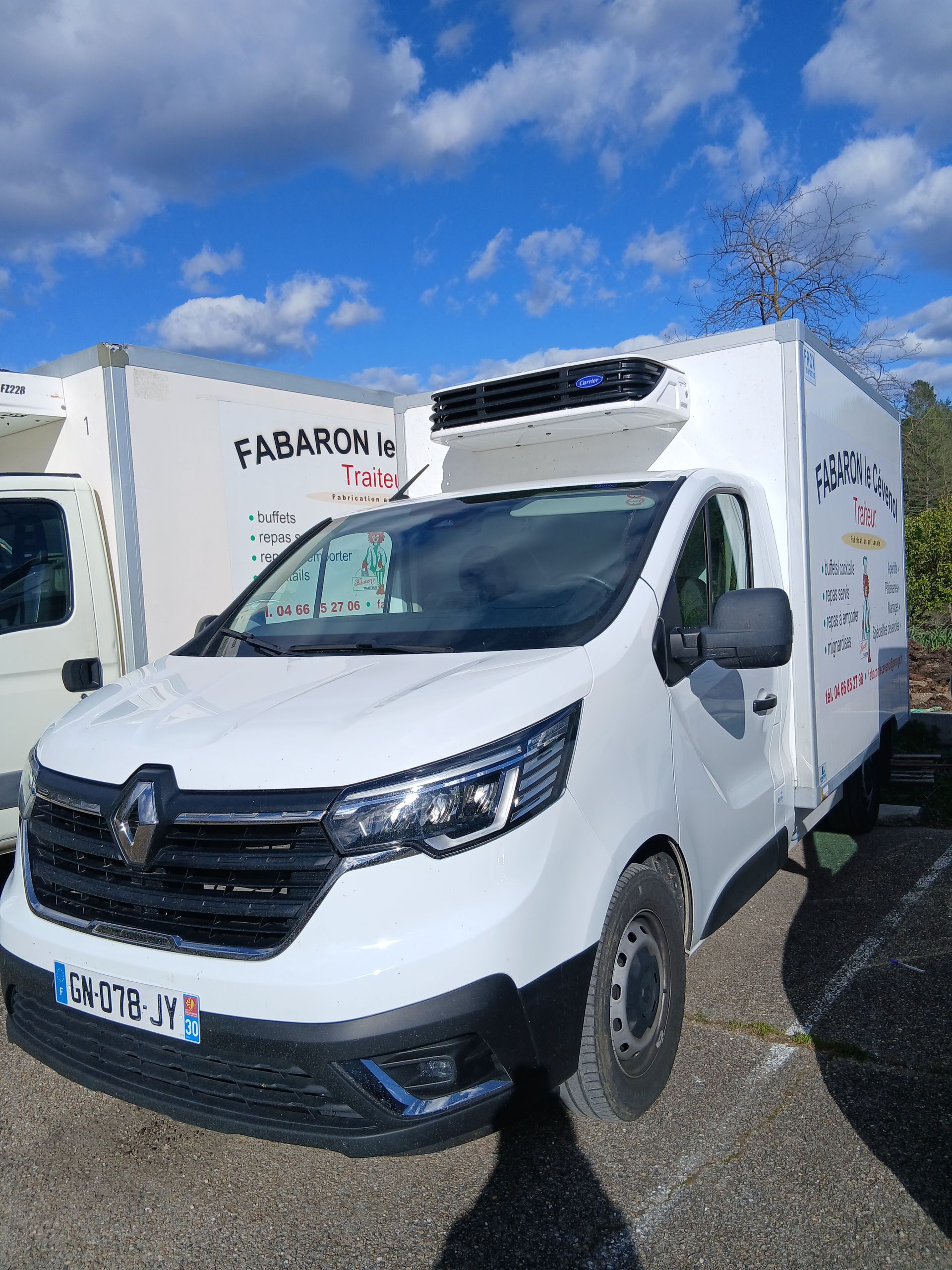Deux camions frigorifiés blancs.