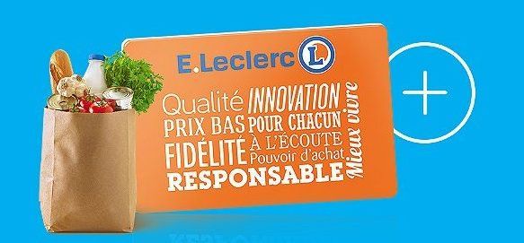 Sac de courses en papier rempli de pain, d'une bouteille de lait, de fanes de carottes et de différents aliments devant la carte E.Leclerc.