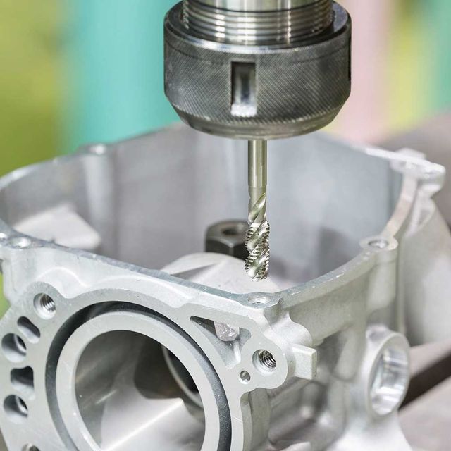 Una máquina está cortando un agujero en un trozo de metal.