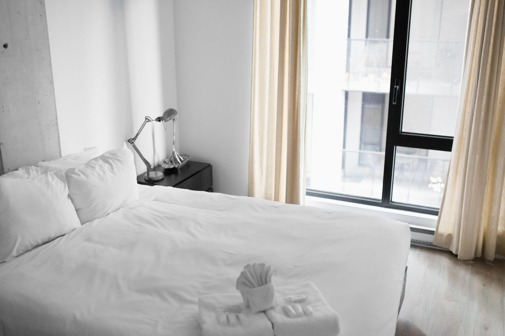 A bedroom with a large bed and a window
