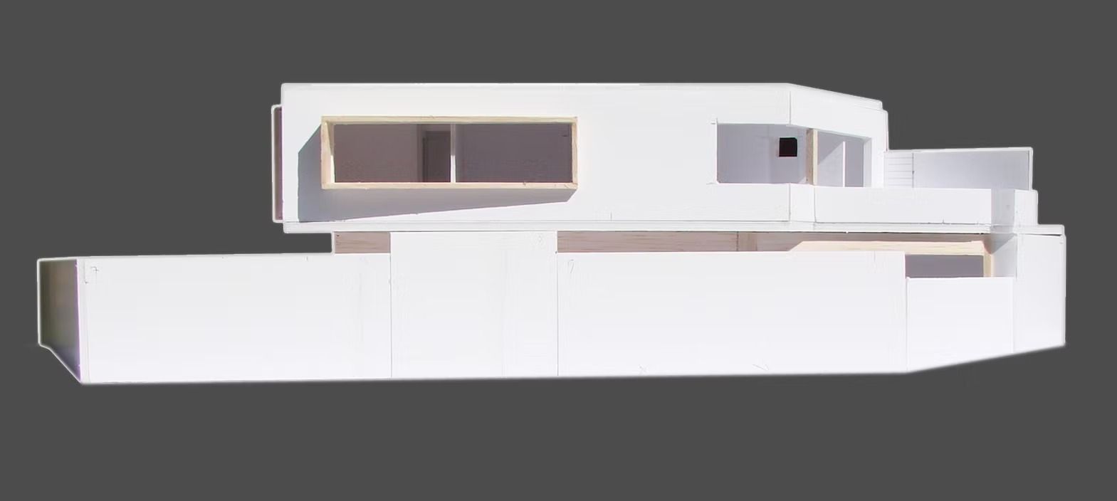 Exterior de un moderno edificio modular blanco sobre un fondo gris.