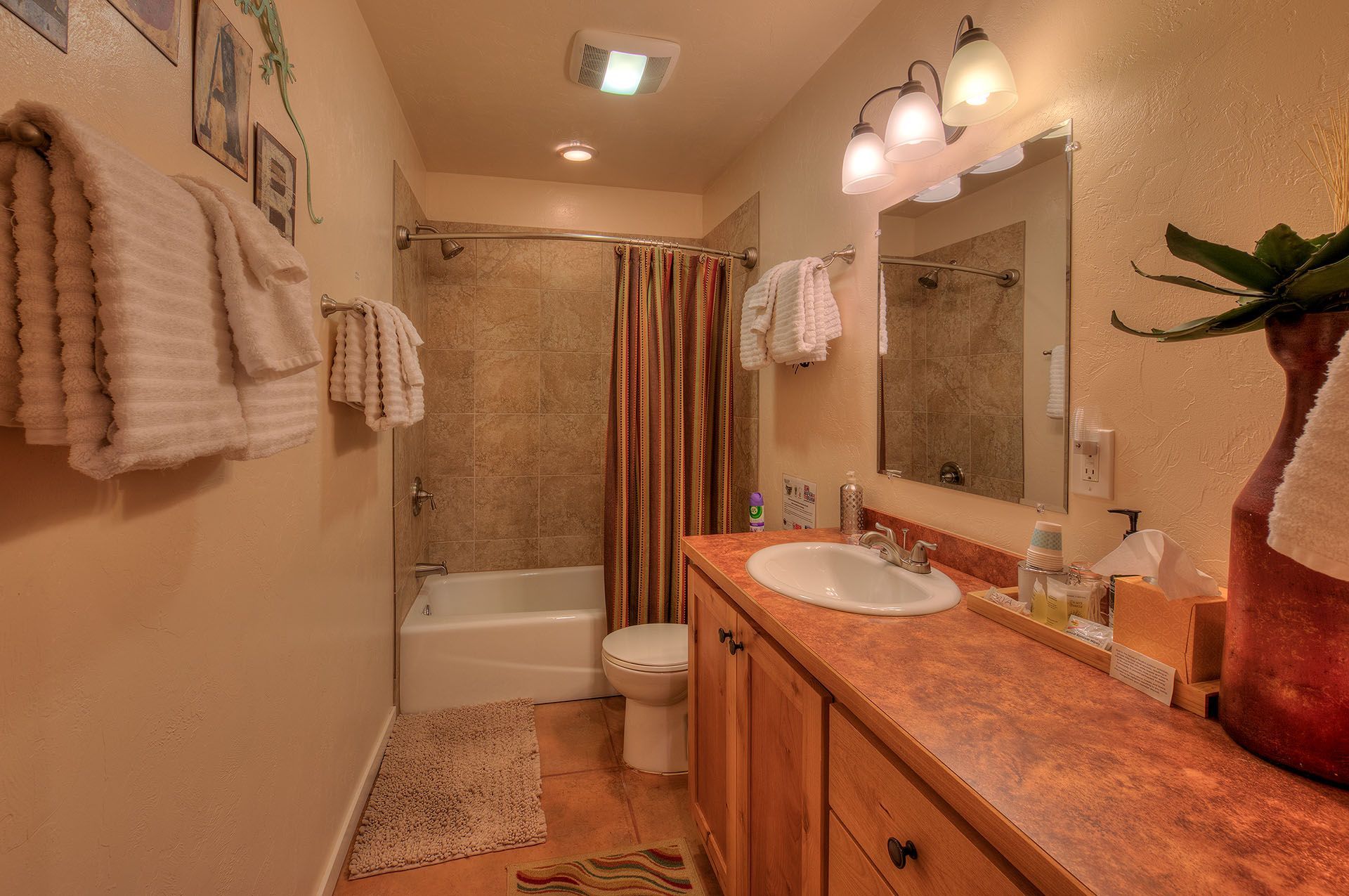 Moab, Utah Oleander Place vacation rental Bathroom Beige walls, brown cabinets, and white towels.