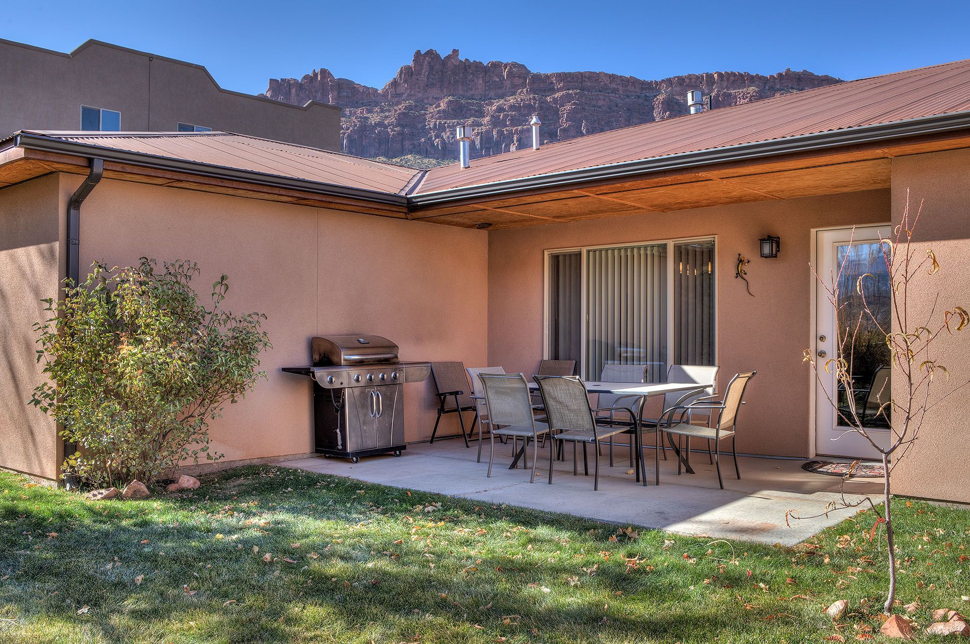 Moab, Utah Oleander Place vacation rental Patio with table and chairs, grill, and view of red rock mountains.