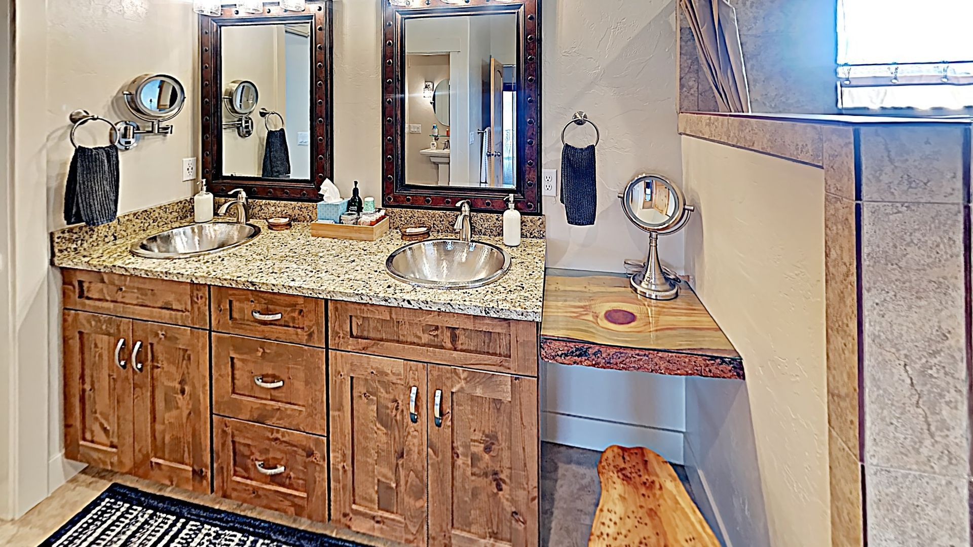 Village Place Moab vacation rental Bathroom with dual sinks, wooden vanity, granite countertop, two mirrors