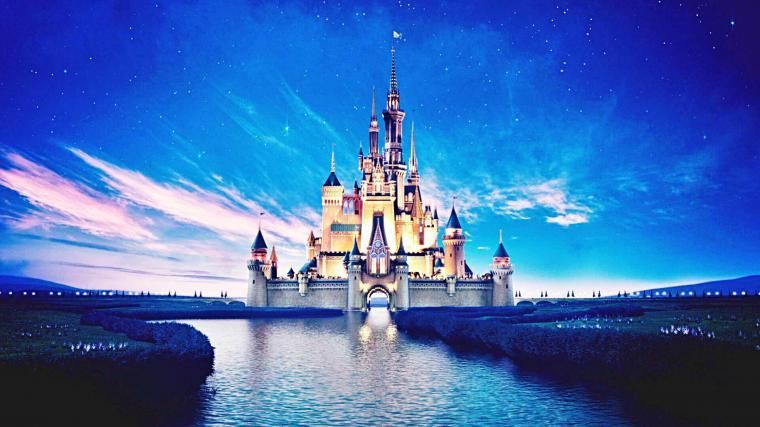 A disney castle is sitting on top of a body of water 15 from our 2 bed 2 bath Orlando Vacation Rental