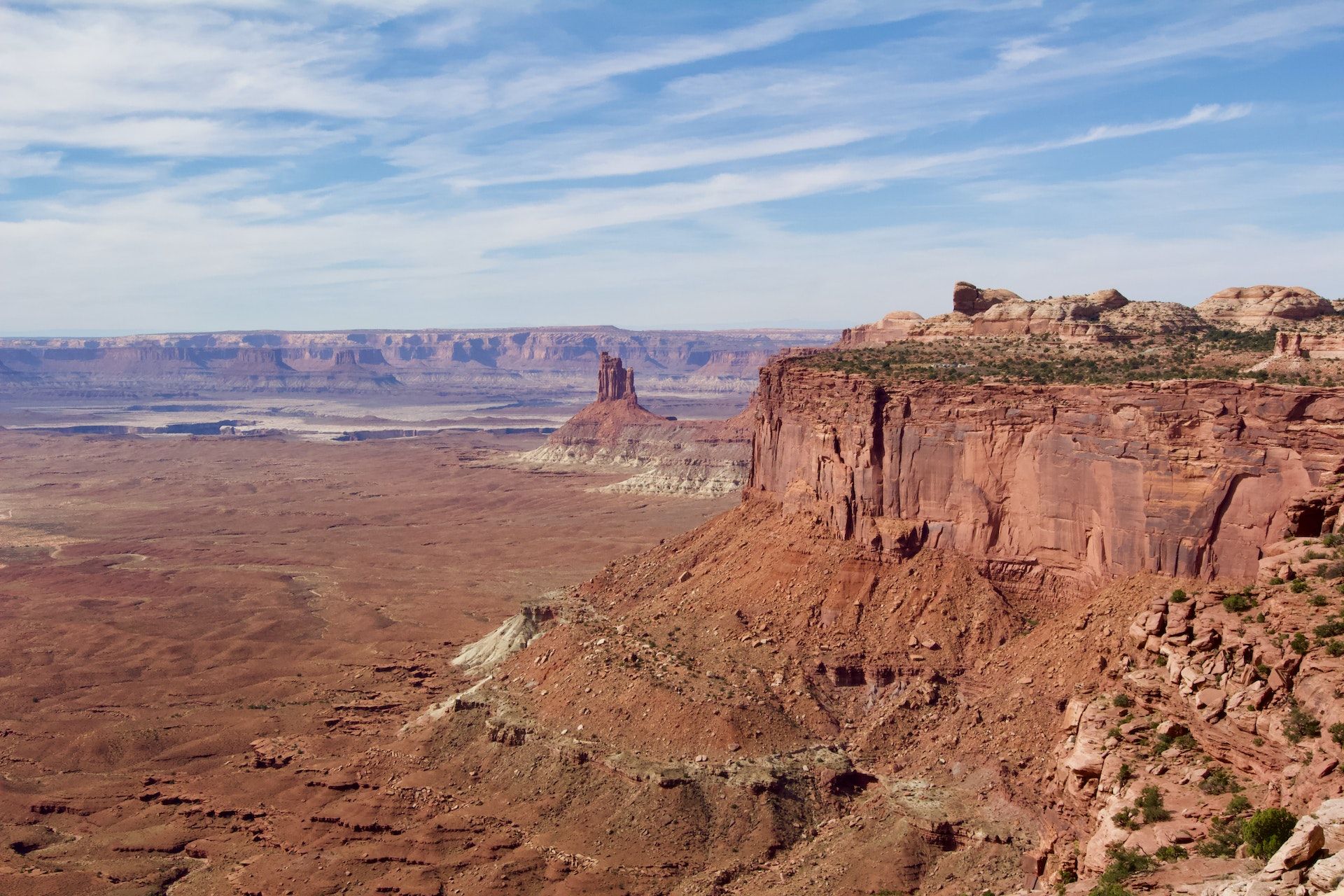 A view of a desert landscape with mountains in the background