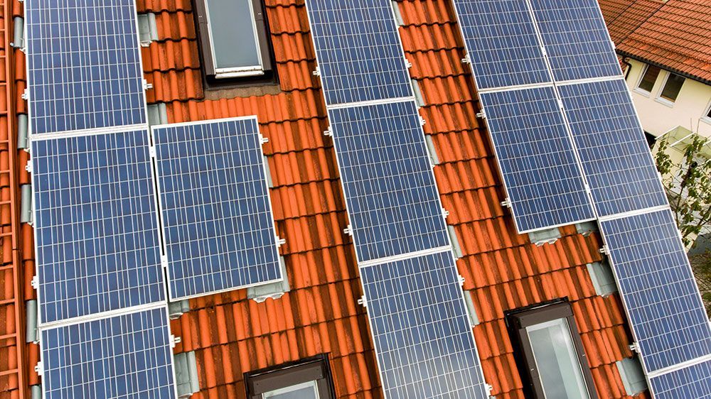 Auf dem Dach eines Hauses befinden sich viele Solarmodule.