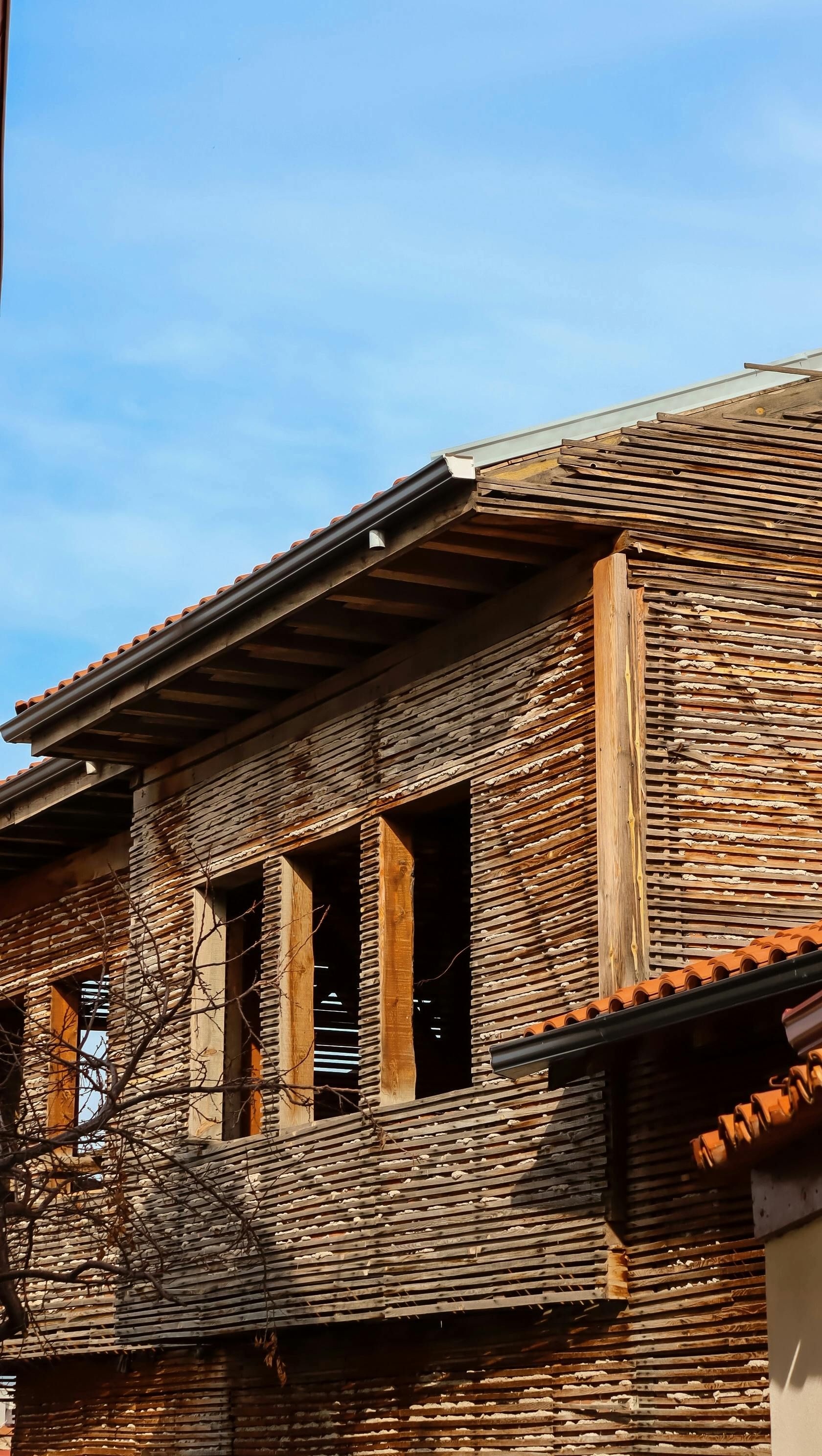 Ein Mann arbeitet an einem kleinen Holzhaus. Foto vom Maler Trinkl - Inhaber Andreas Füglistaler