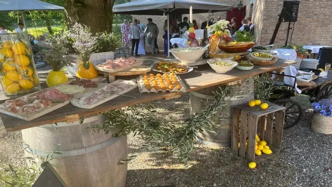 A buffet table with a lot of food on it.