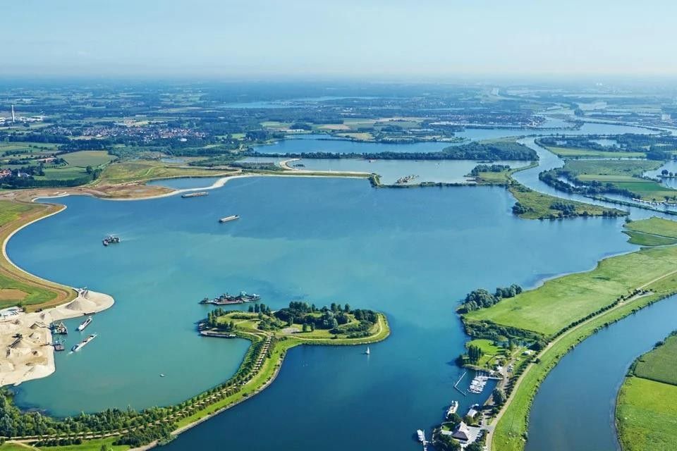 An aerial view of a lake with a small island in the middle