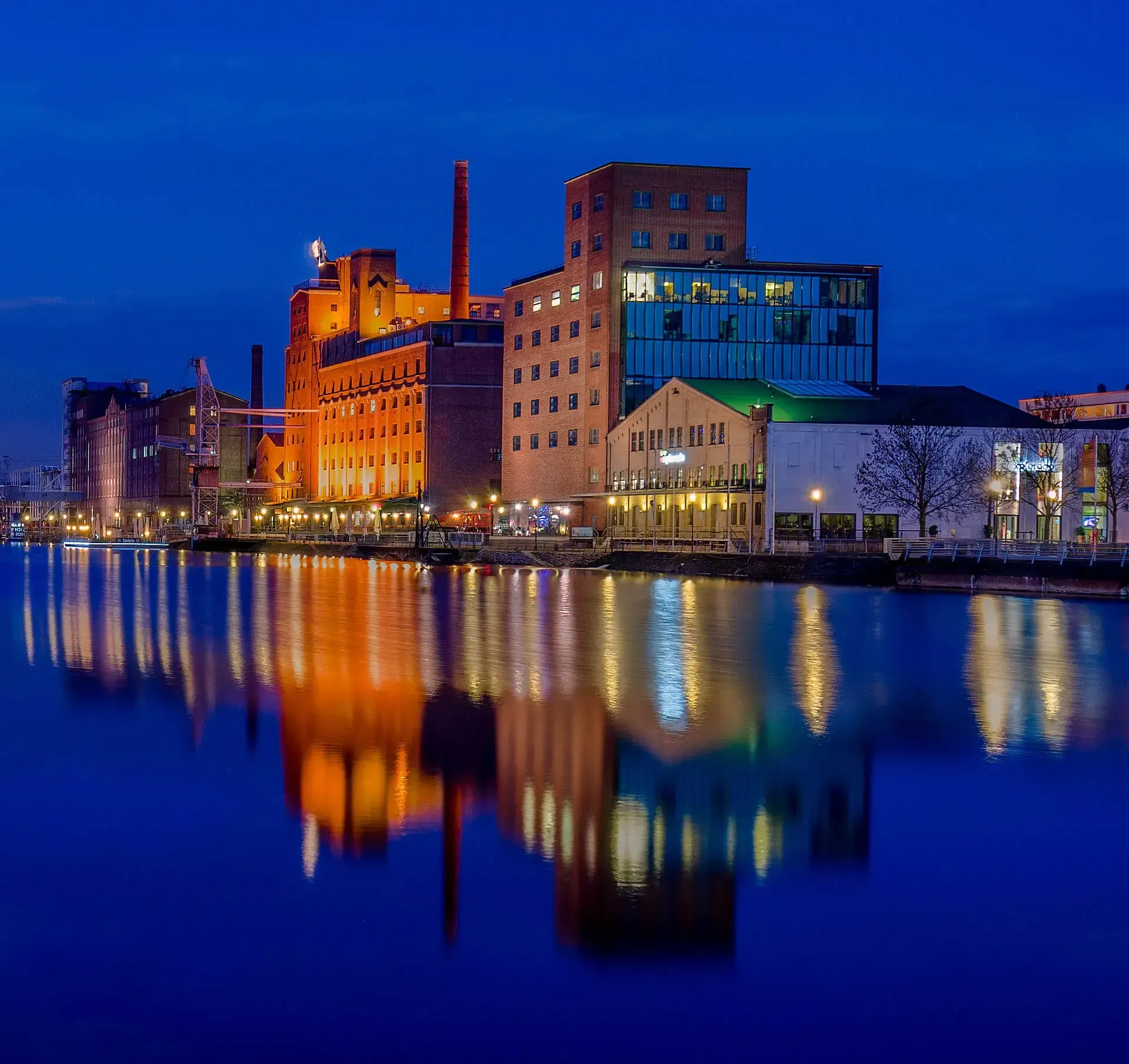 Innenhafen Duisburg (Inner Harbor). A reflection of a building in the water at night