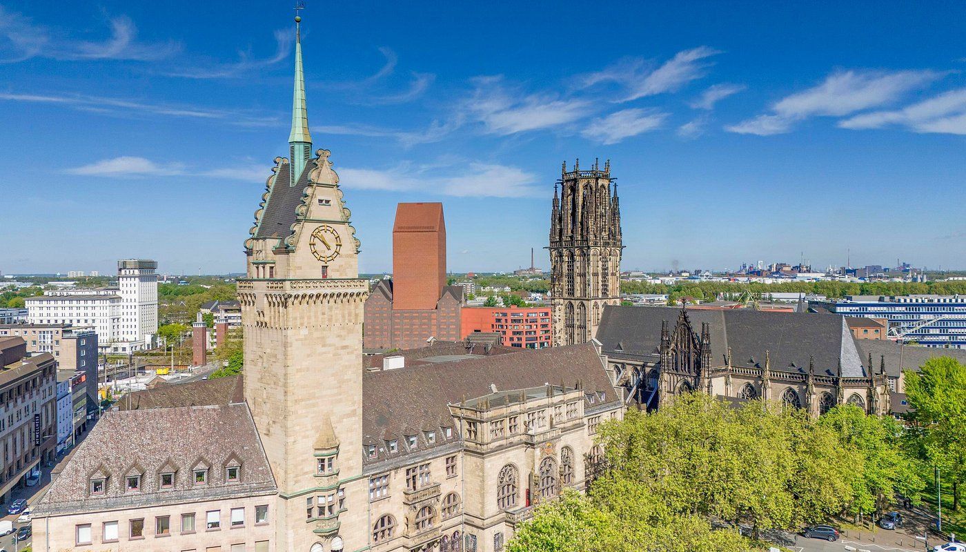 Duisburg Town Hall (Rathaus Duisburg). An aerial view of a city with a clock tower in the foreground.