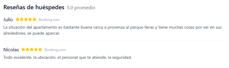 A person with dark curly hair smiling broadly against a plain light-colored background.