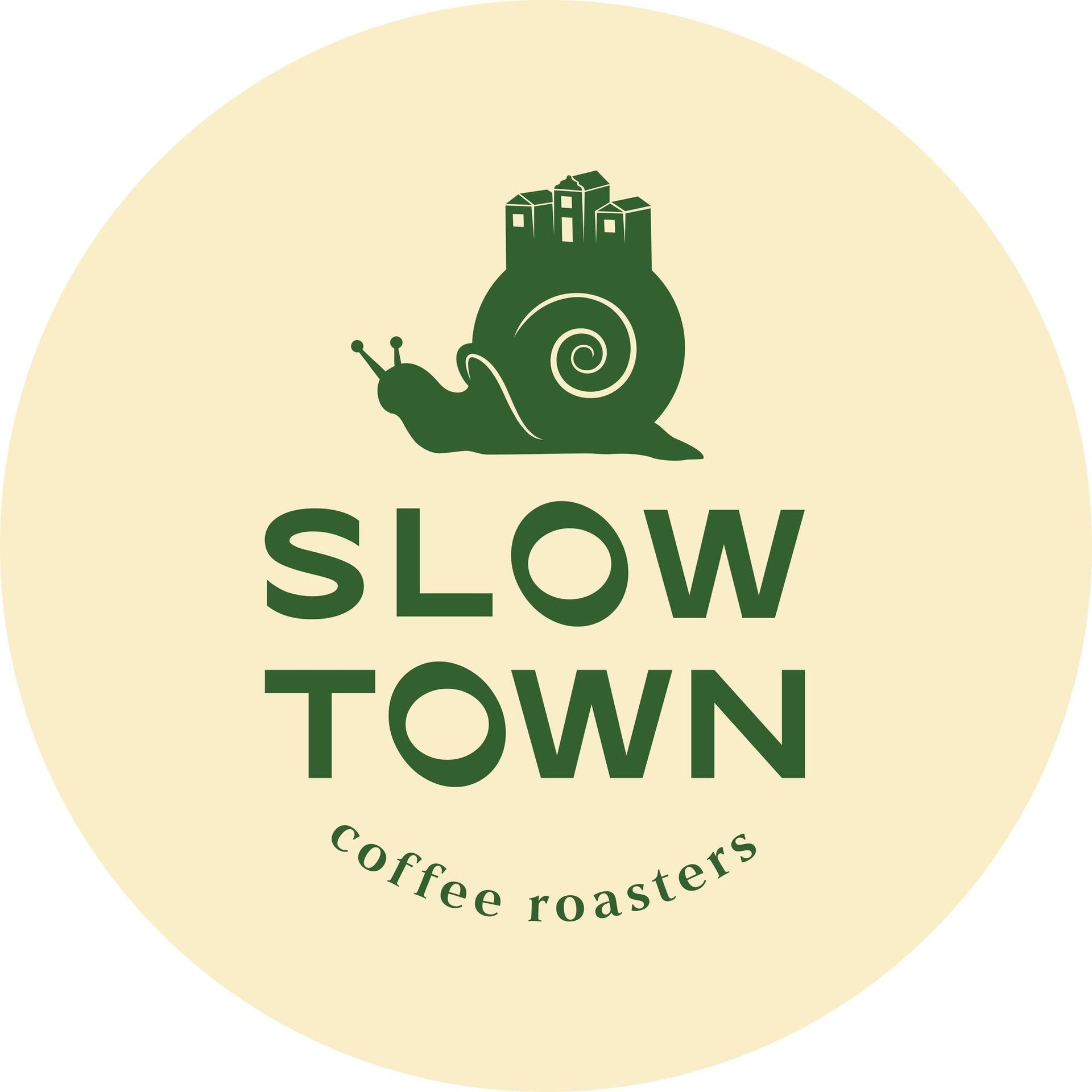 Logo: Green snail with a town on its back, 