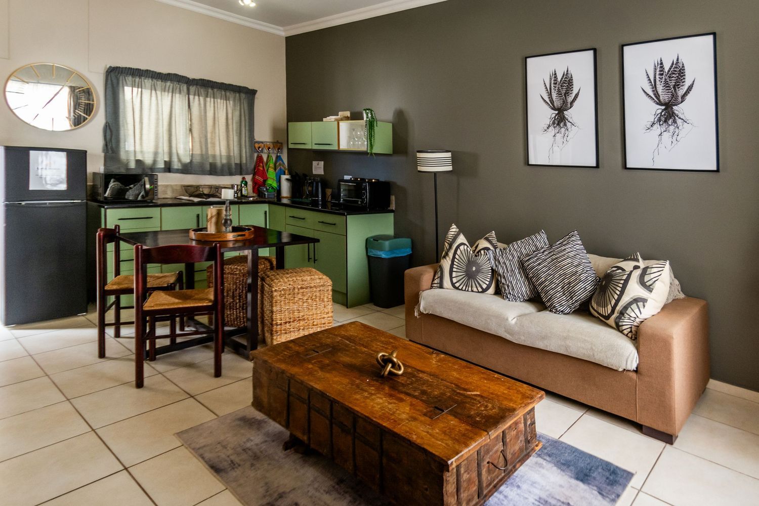 Small apartment interior with kitchen, living area, and a coffee table.