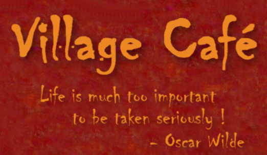 Village Café logo with orange text on a textured red background and a quote by Oscar Wilde.