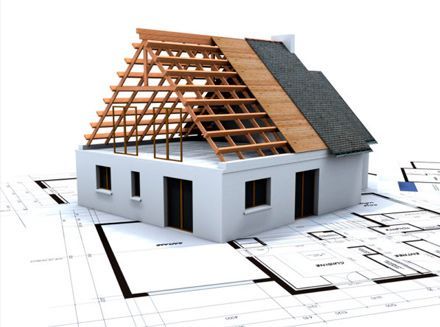 Una casa modelo con techo de madera está colocada encima de un plano.